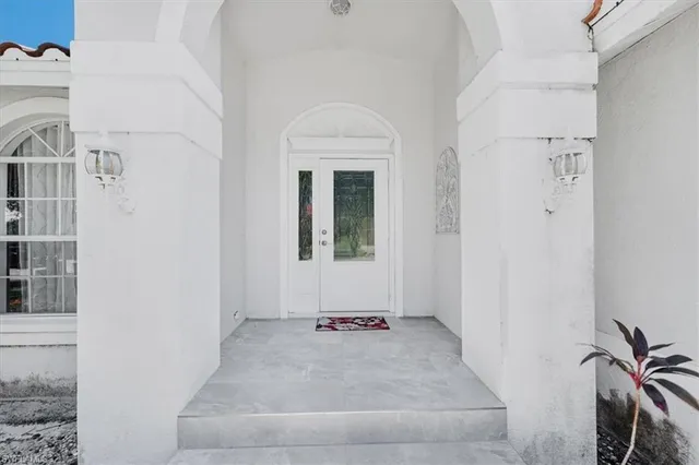 a view of a livingroom with wooden floor and a white door