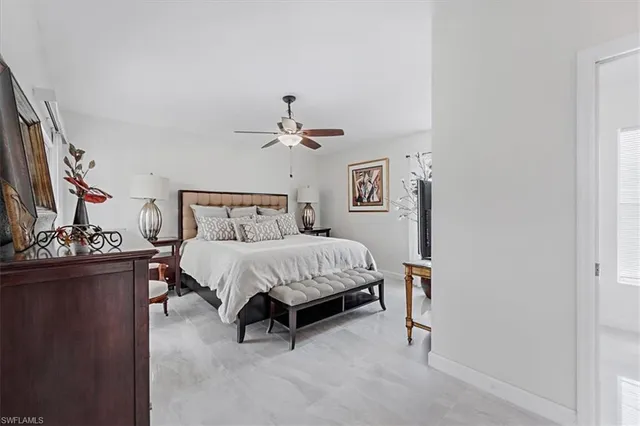 a bedroom with a bed and a flat tv screen on dresser