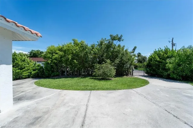 an aerial view of a house with a yard and a large pool