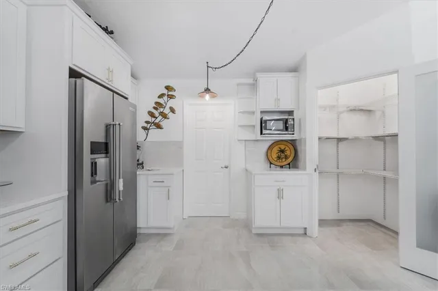 a view of kitchen and refrigerator in kitchen