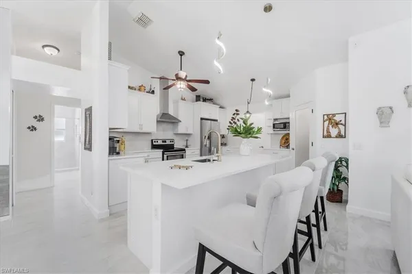 a kitchen with kitchen island cabinets and refrigerator