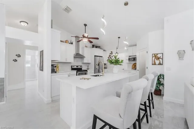 a kitchen with kitchen island cabinets and refrigerator