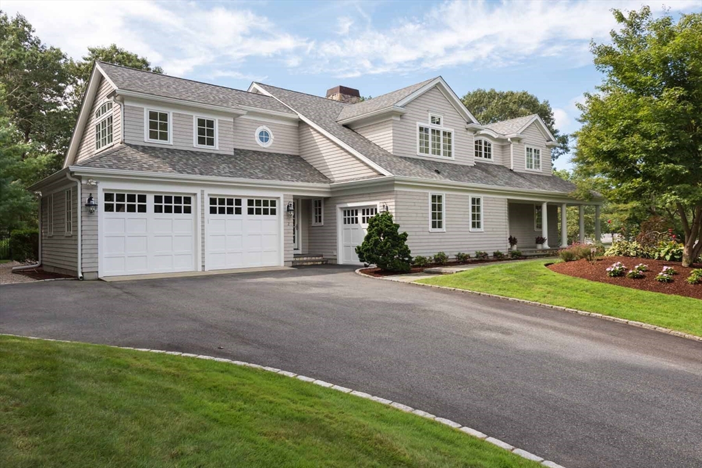 2 Open Drive Sandwich, MA 02563 - Photo 2 of 34 a front view of a house with a yard and garage