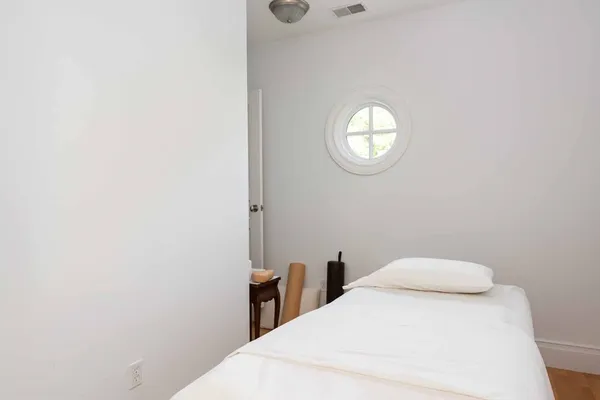 a bedroom with a bed and a table