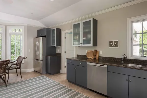 a kitchen with a sink refrigerator and dining table