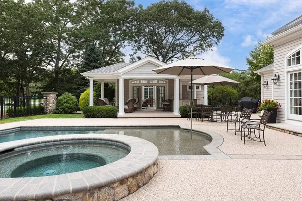 a view of a house with swimming pool and sitting area