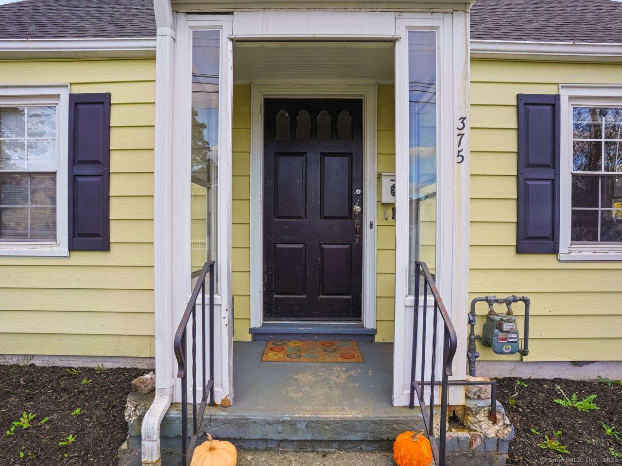 375 Ruth Street Bridgeport, CT 06606 - Photo 3 of 27 a front view of a house with a porch