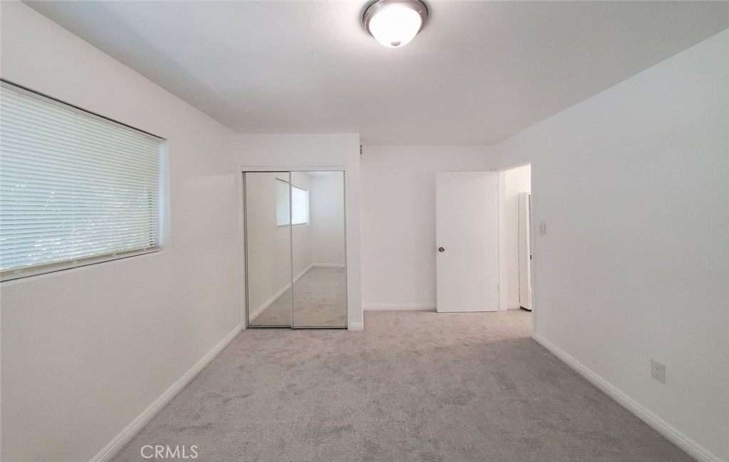2020 West 23rd Street, Unit 17 Long Beach, CA 90810 - Photo 22 of 28 an empty room with windows