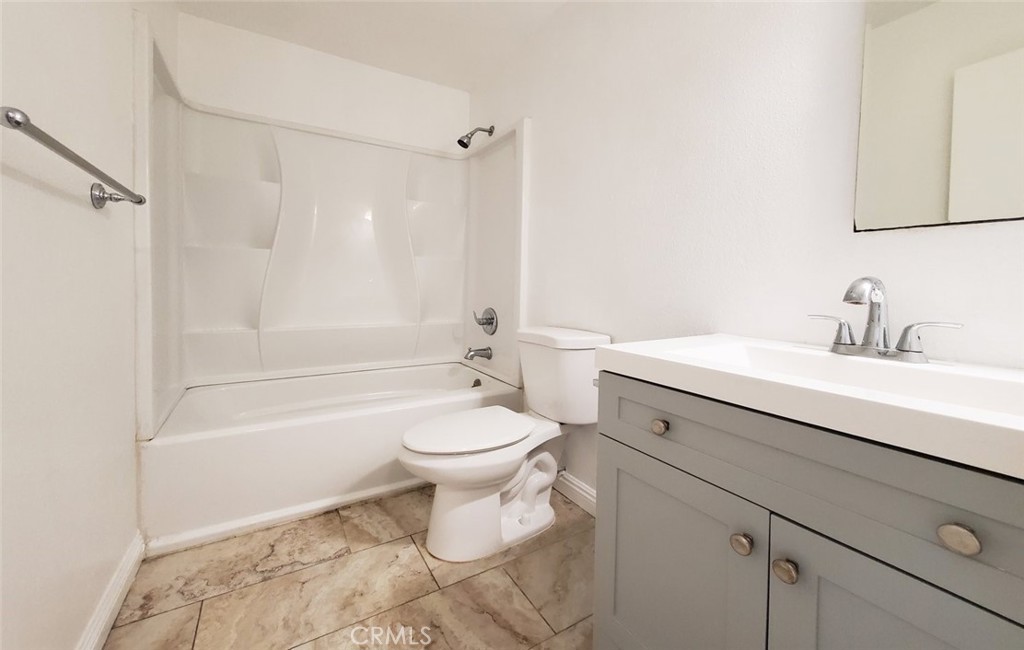 2020 West 23rd Street, Unit 17 Long Beach, CA 90810 - Photo 23 of 28 a bathroom with a sink a toilet and shower