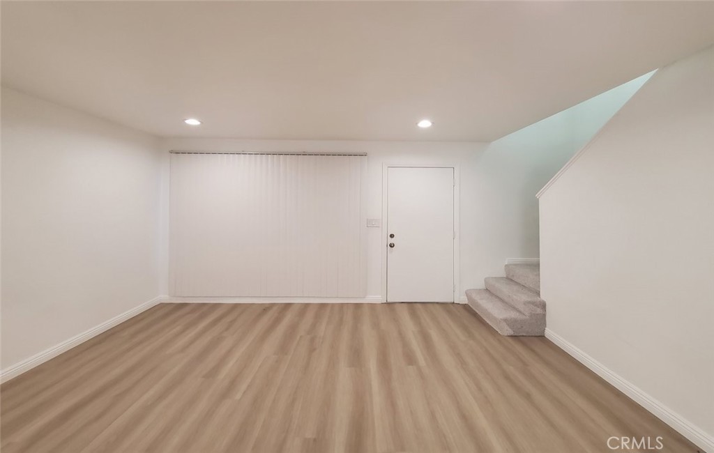 2020 West 23rd Street, Unit 17 Long Beach, CA 90810 - Photo 8 of 28 a view of room with wooden floor