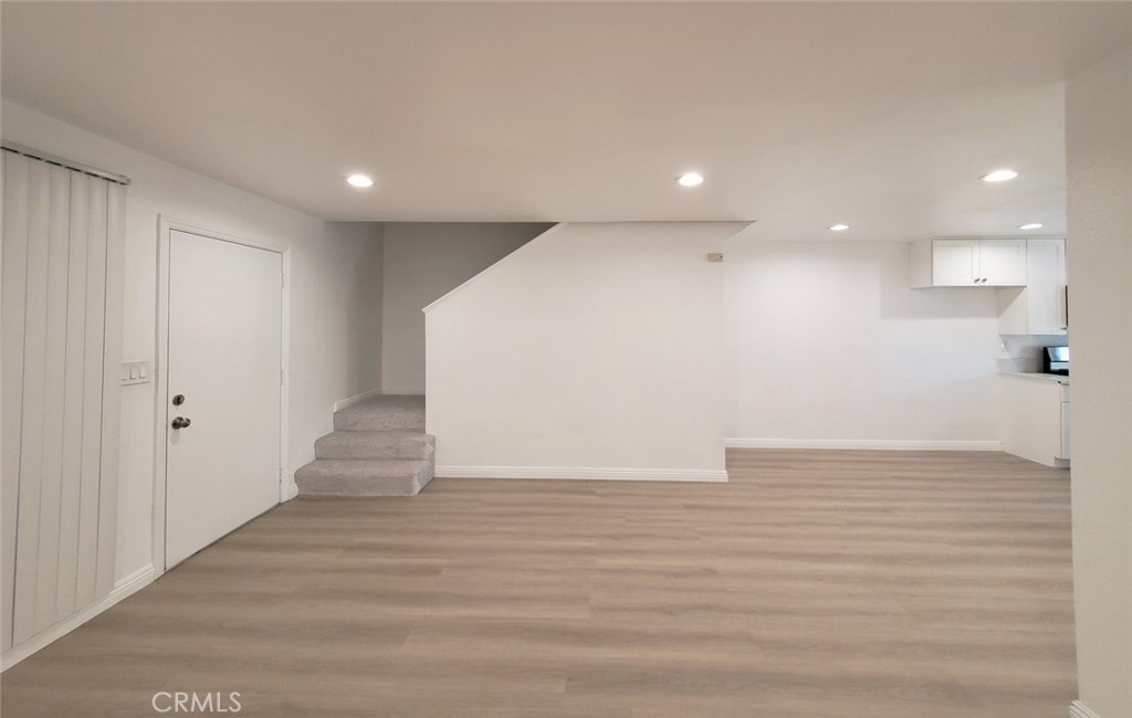2020 West 23rd Street, Unit 17 Long Beach, CA 90810 - Photo 9 of 28 a view of an empty room with wooden floor