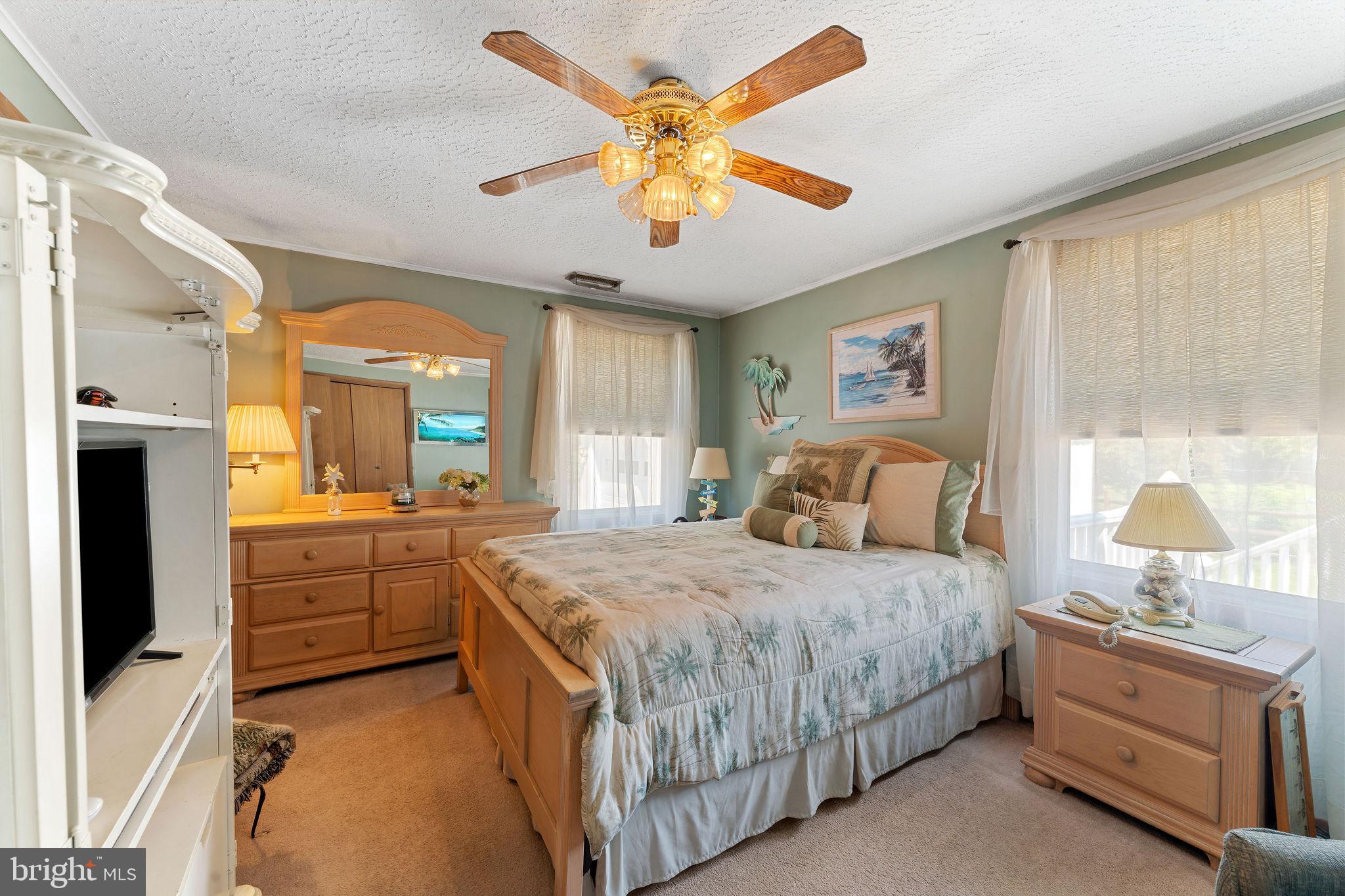 116 Kent Point Road Stevensville, MD 21666 - Photo 21 of 32 a bedroom with a large bed and a window