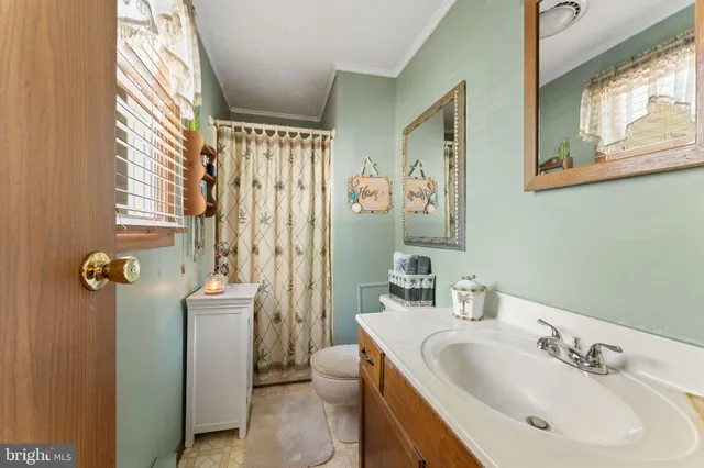 a bathroom with a sink and mirror with toilet
