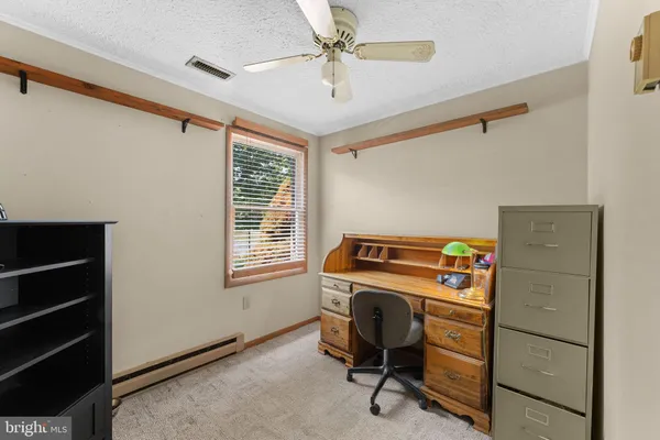 a bedroom with a bed and a ceiling fan