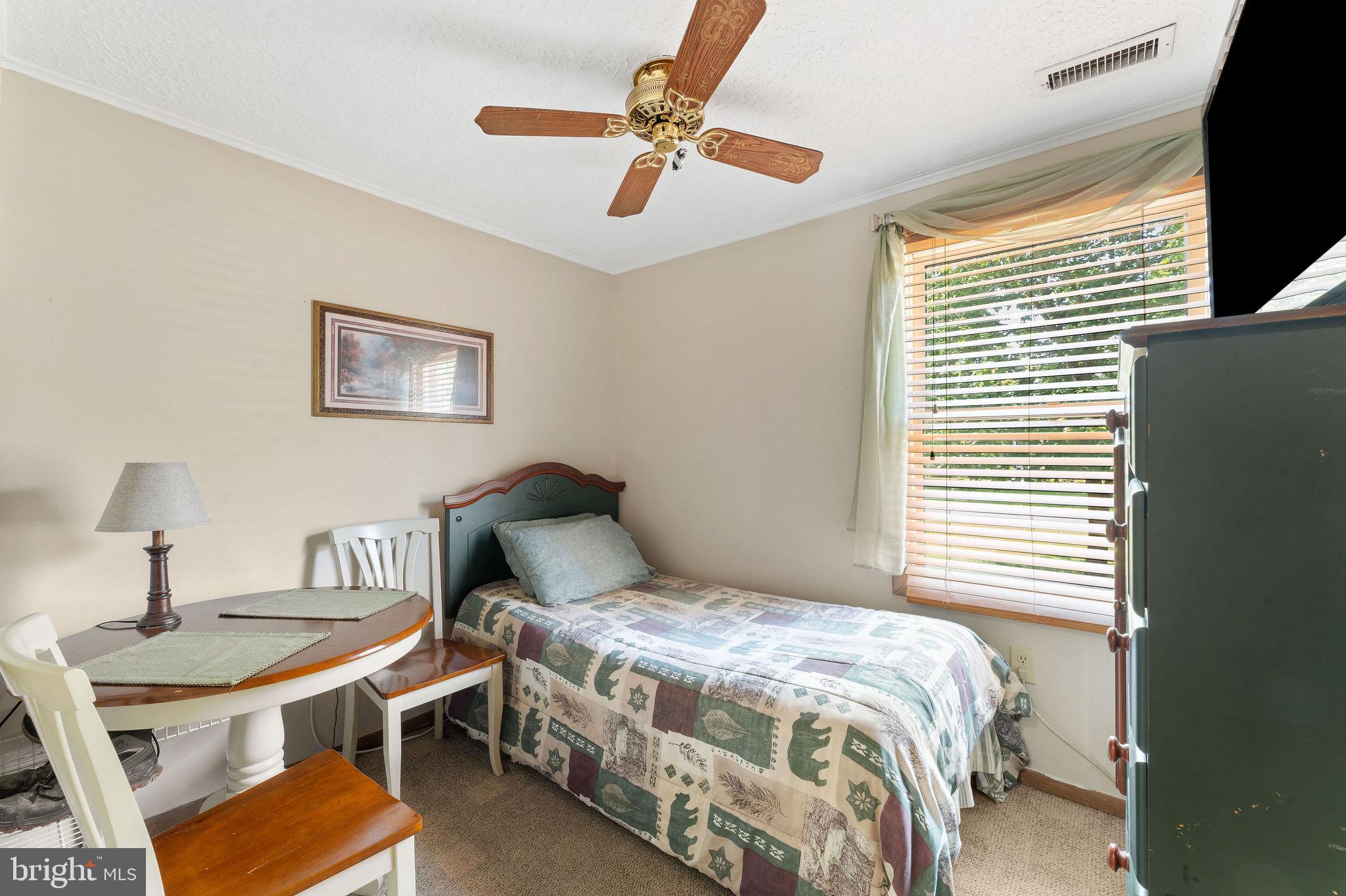 116 Kent Point Road Stevensville, MD 21666 - Photo 24 of 32 a bedroom with a bed and a table in it
