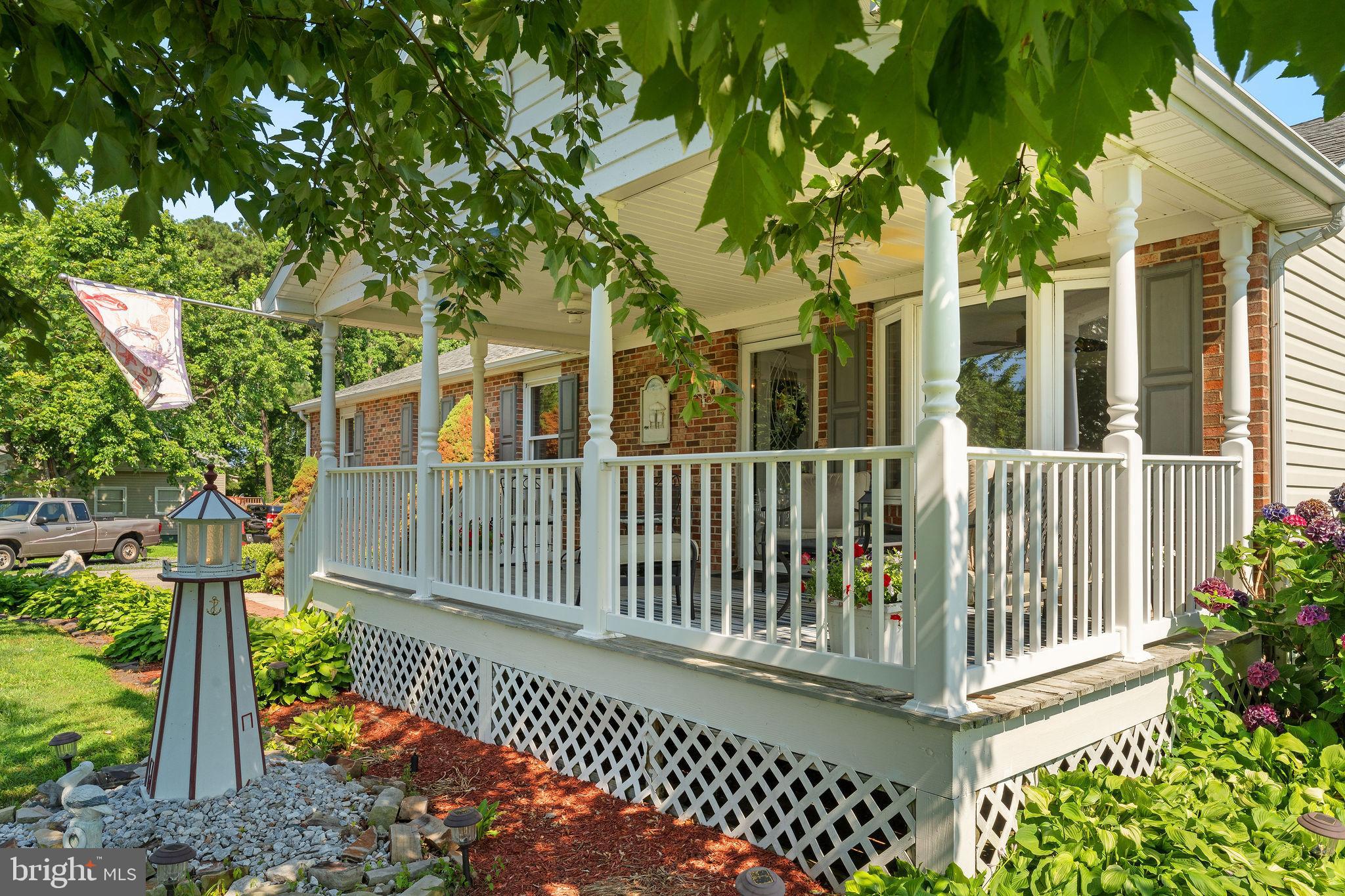 116 Kent Point Road Stevensville, MD 21666 - Photo 9 of 32 a porch with a bench next to a yard