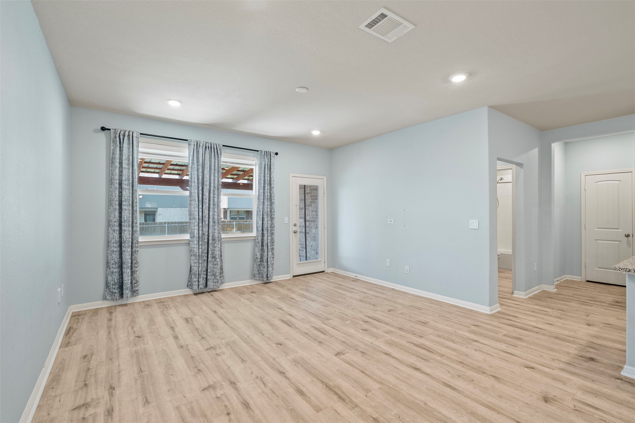 120 Ellinger Road Georgetown, TX 78626 - Photo 15 of 28 Spacious room featuring wood-finish flooring, recessed lighting, and light blue walls
