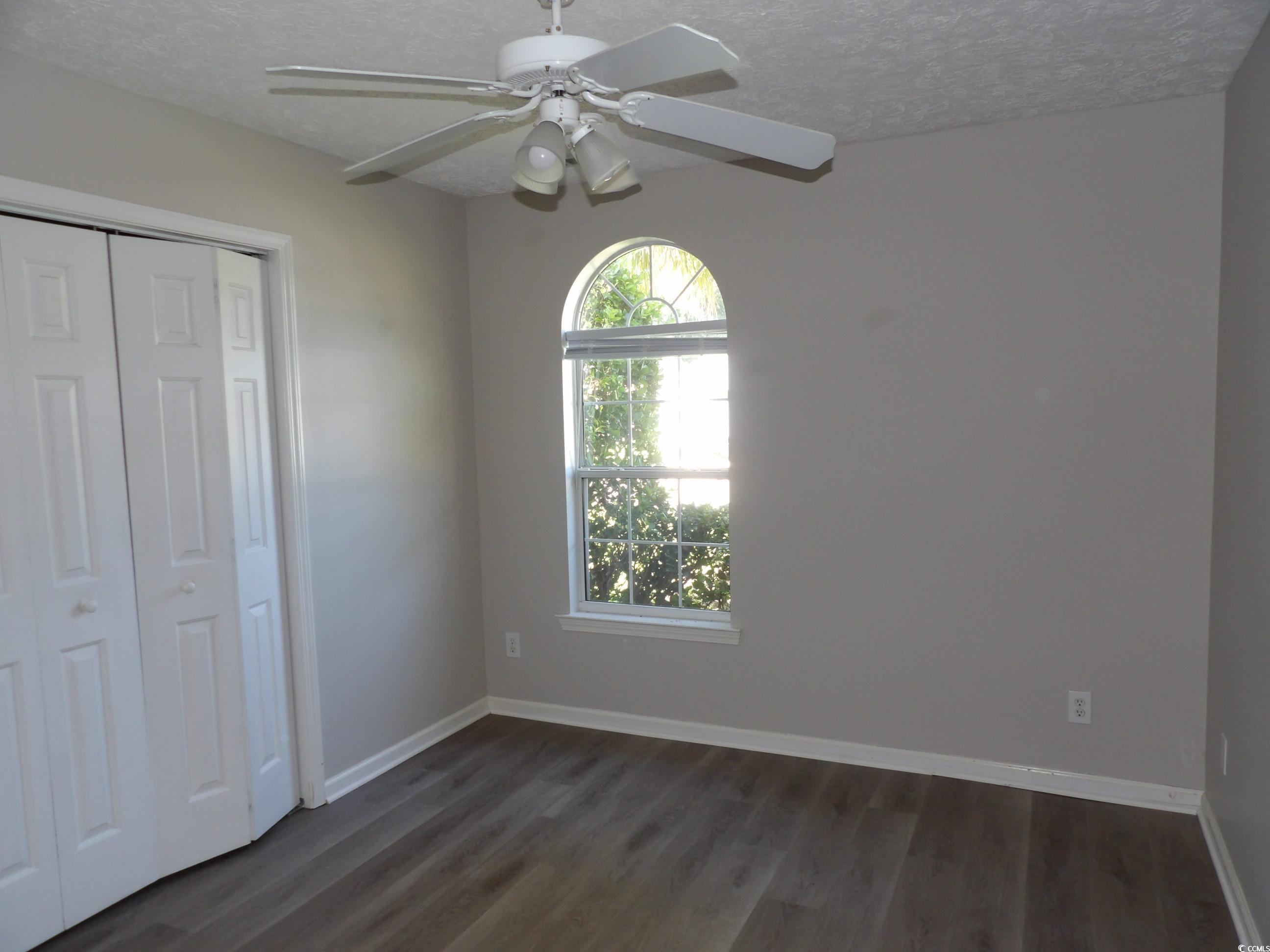 7971 Spruce Lane Murrells Inlet, SC 29576 - Photo 19 of 27 Unfurnished bedroom featuring a closet, a textured
