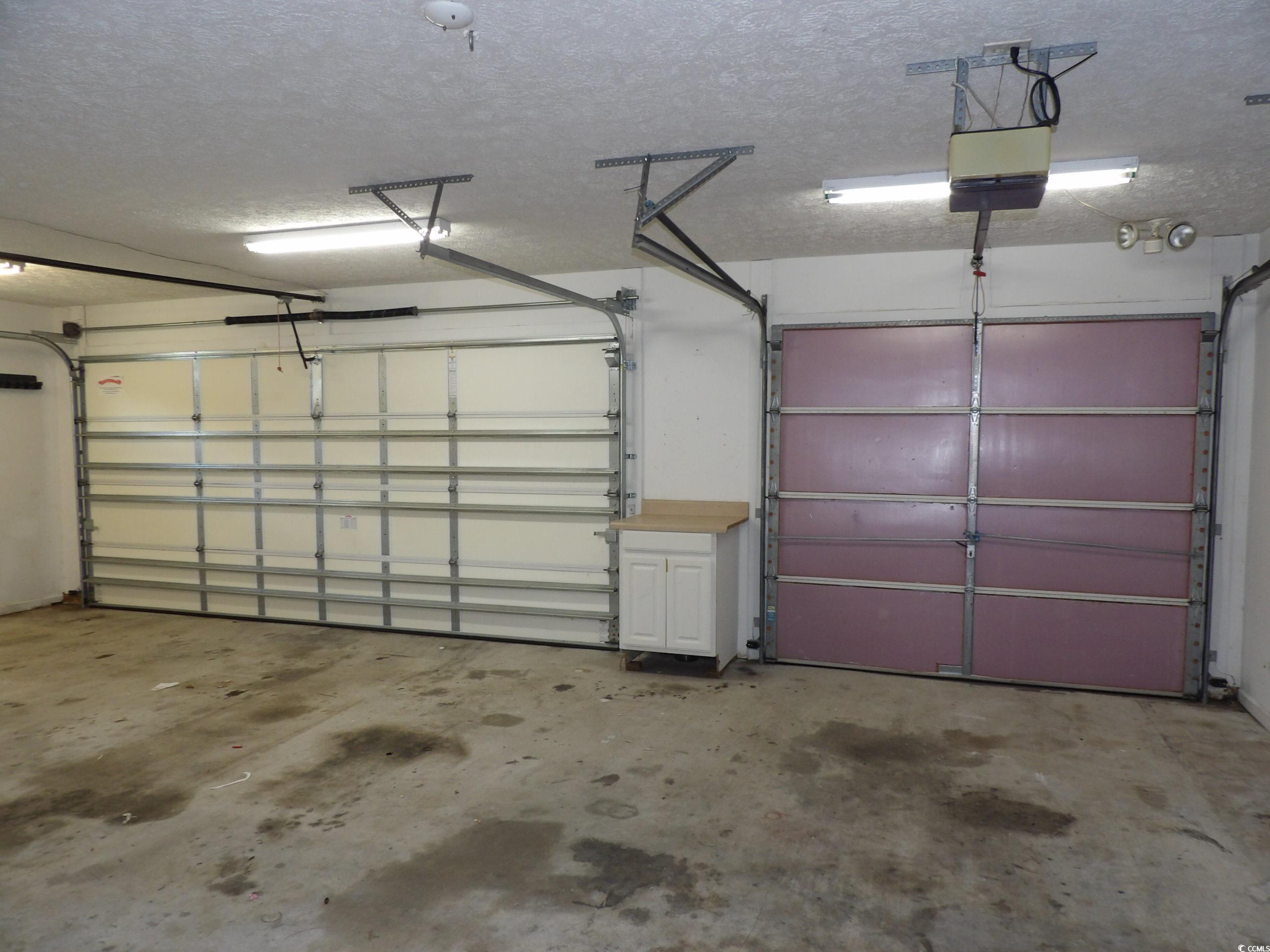 7971 Spruce Lane Murrells Inlet, SC 29576 - Photo 23 of 27 Garage with a garage door opener
