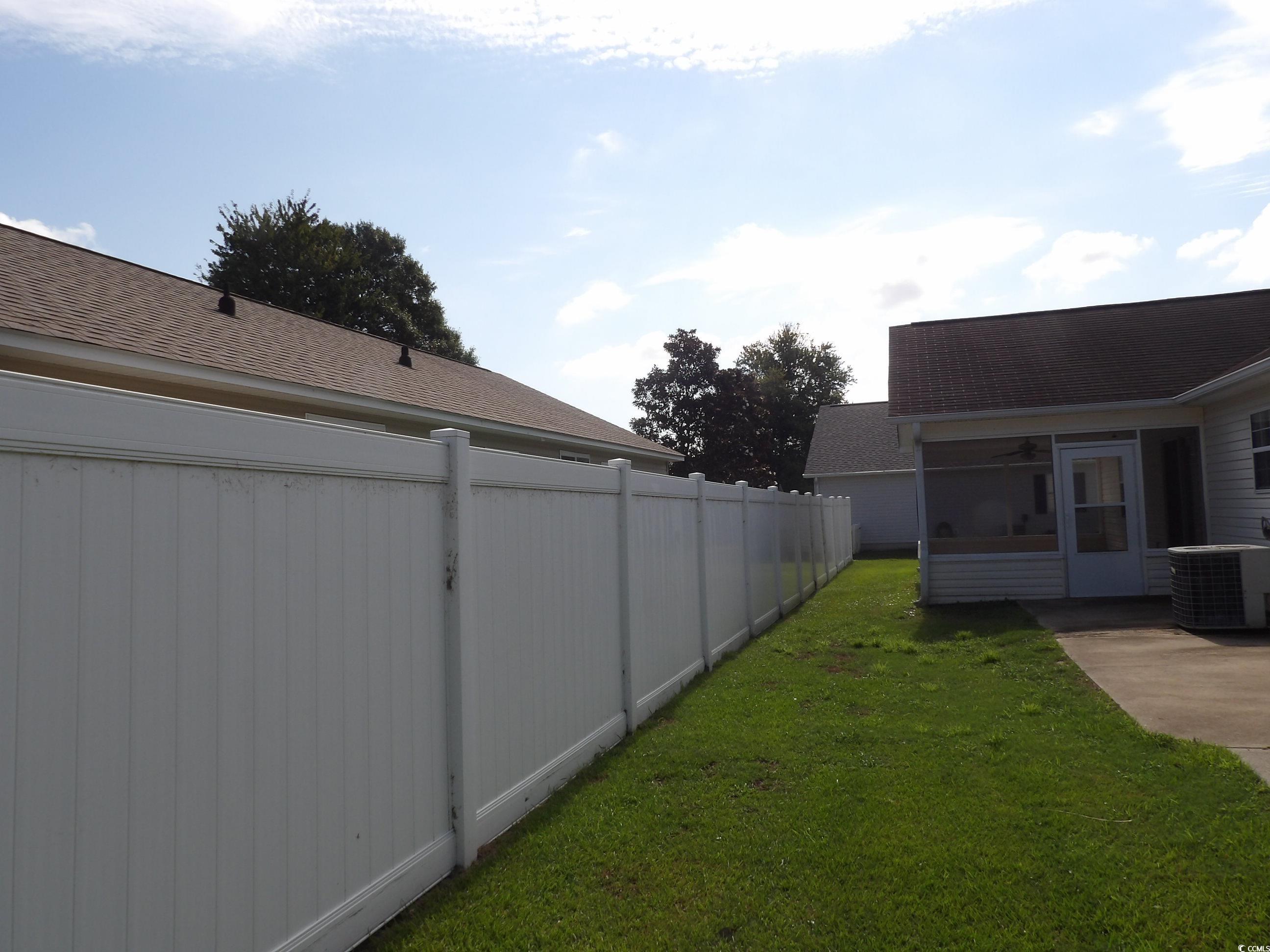 7971 Spruce Lane Murrells Inlet, SC 29576 - Photo 26 of 27 View of yard with a sunroom and central AC