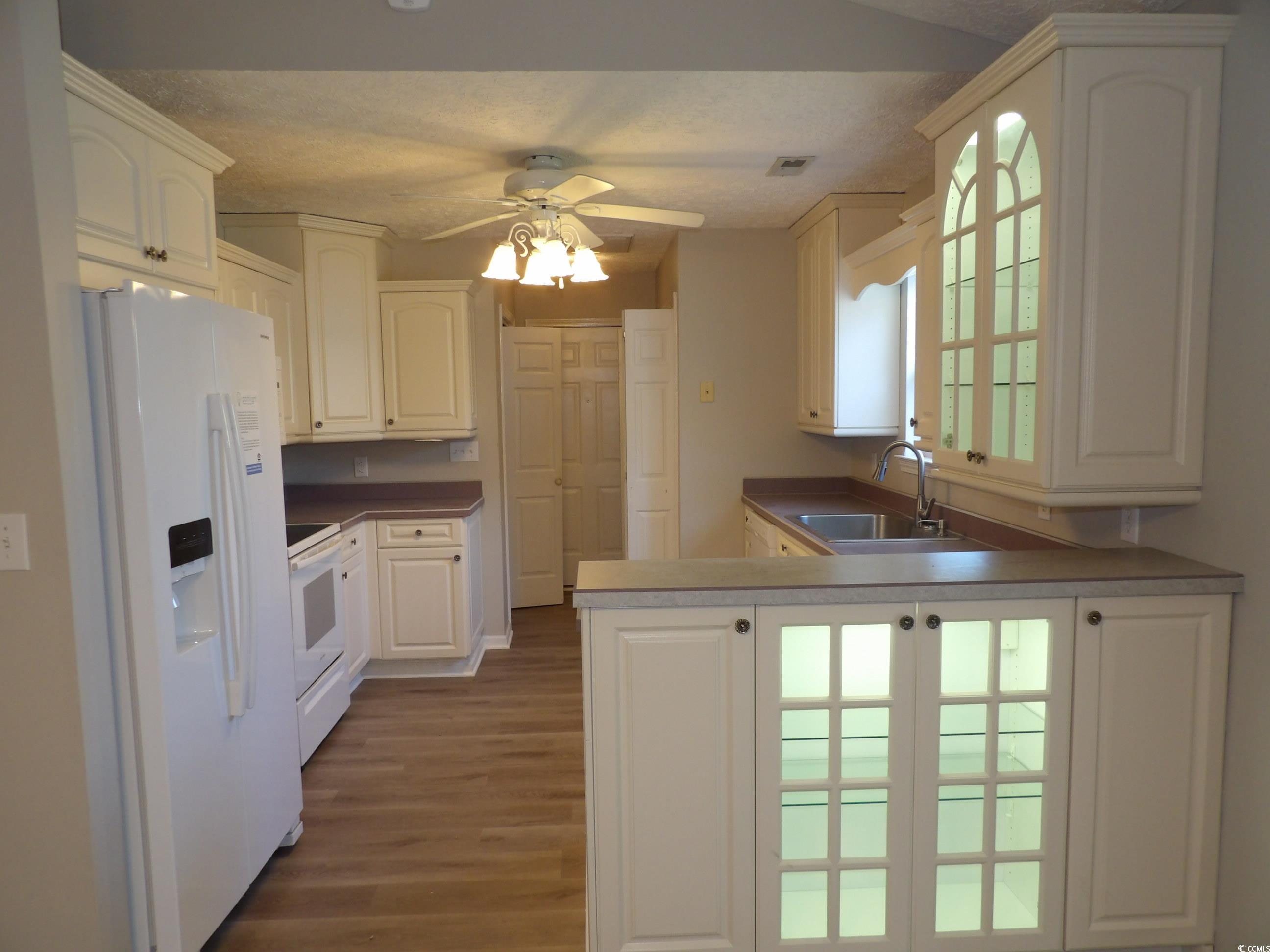 7971 Spruce Lane Murrells Inlet, SC 29576 - Photo 6 of 27 Kitchen featuring white appliances, sink, plenty o