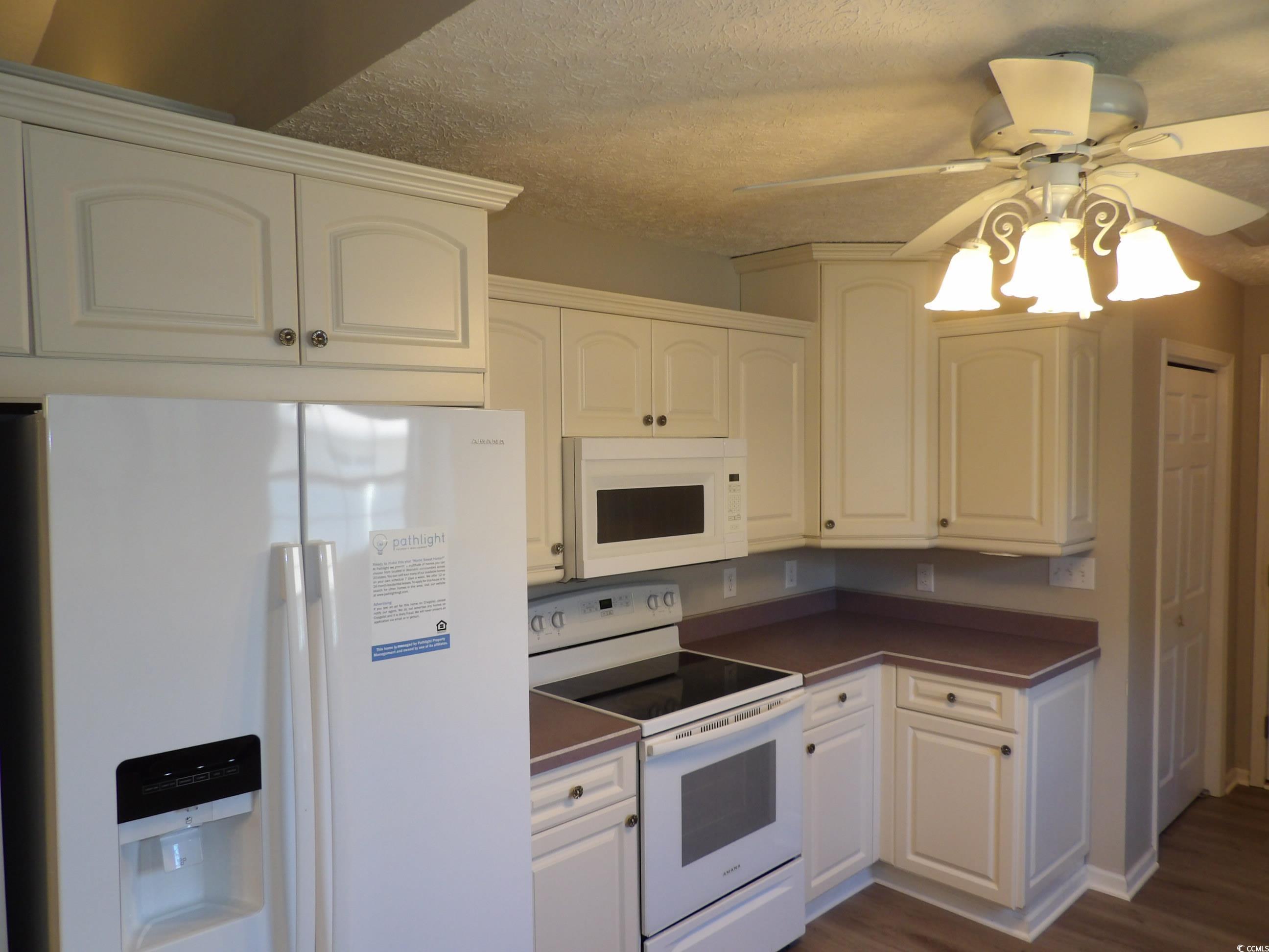 7971 Spruce Lane Murrells Inlet, SC 29576 - Photo 7 of 27 Kitchen featuring ceiling fan, dark hardwood / woo