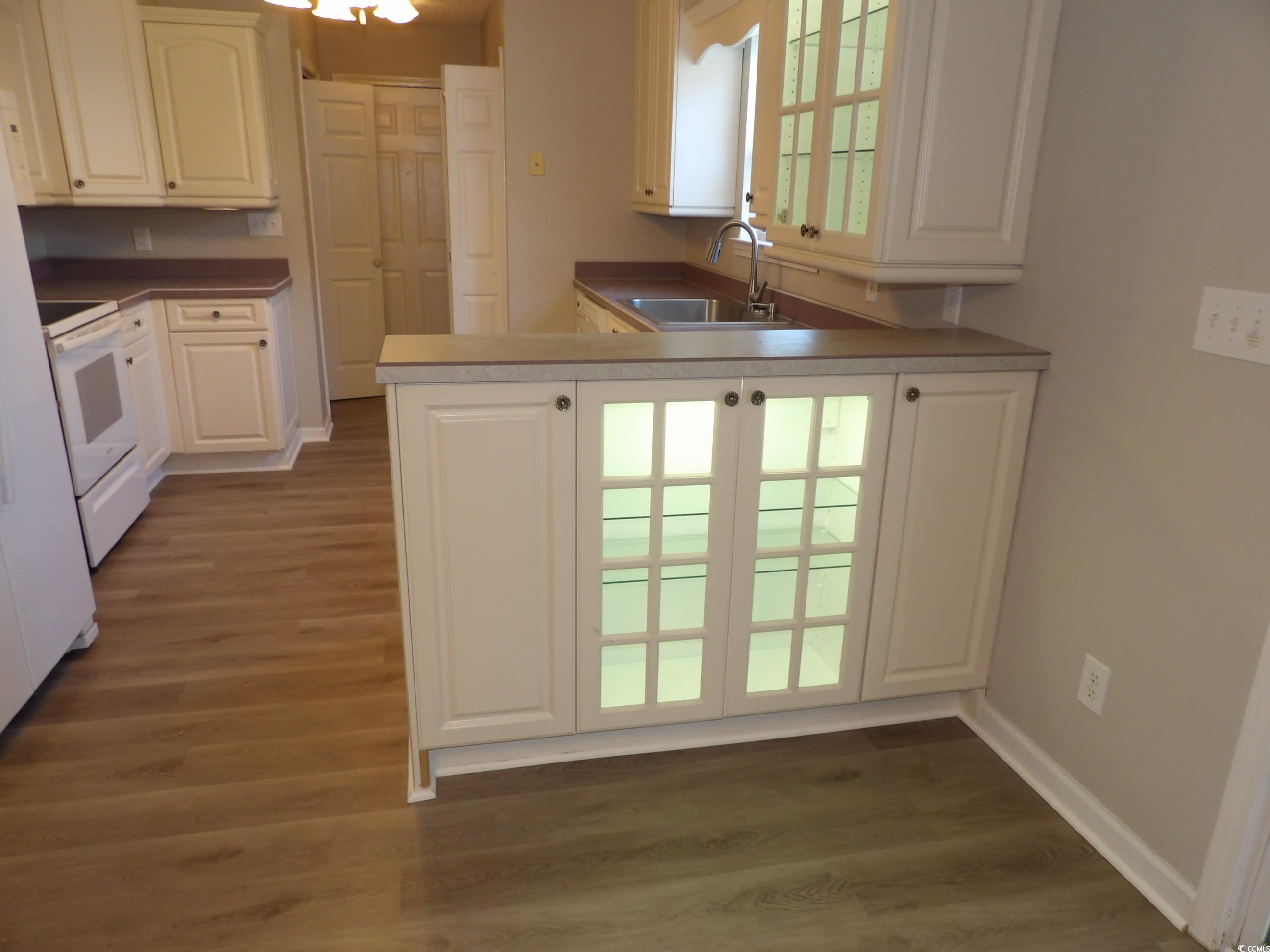 7971 Spruce Lane Murrells Inlet, SC 29576 - Photo 10 of 27 Kitchen with white cabinets, sink, kitchen peninsu
