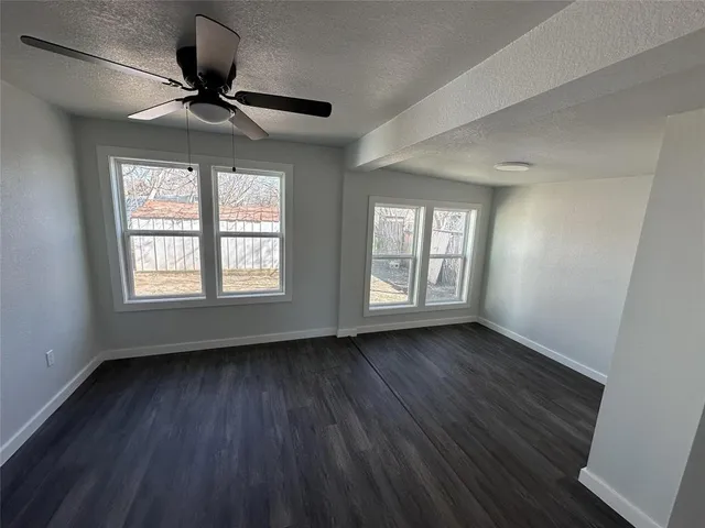 a bathroom with a toilet sink a window and mirror