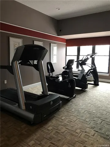 a room with pool table and windows