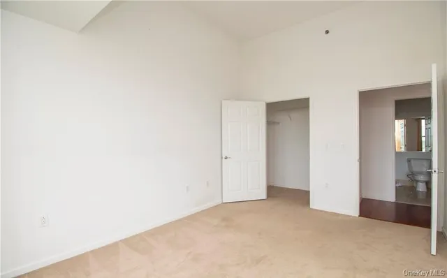 a bathroom with a shower sink vanity mirror and toilet