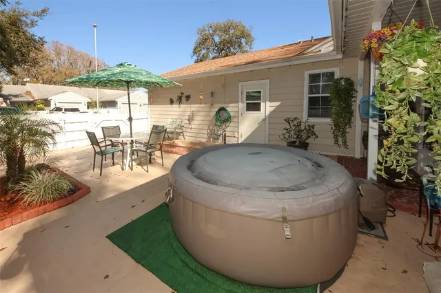 a spacious bedroom with a bed and wooden floor