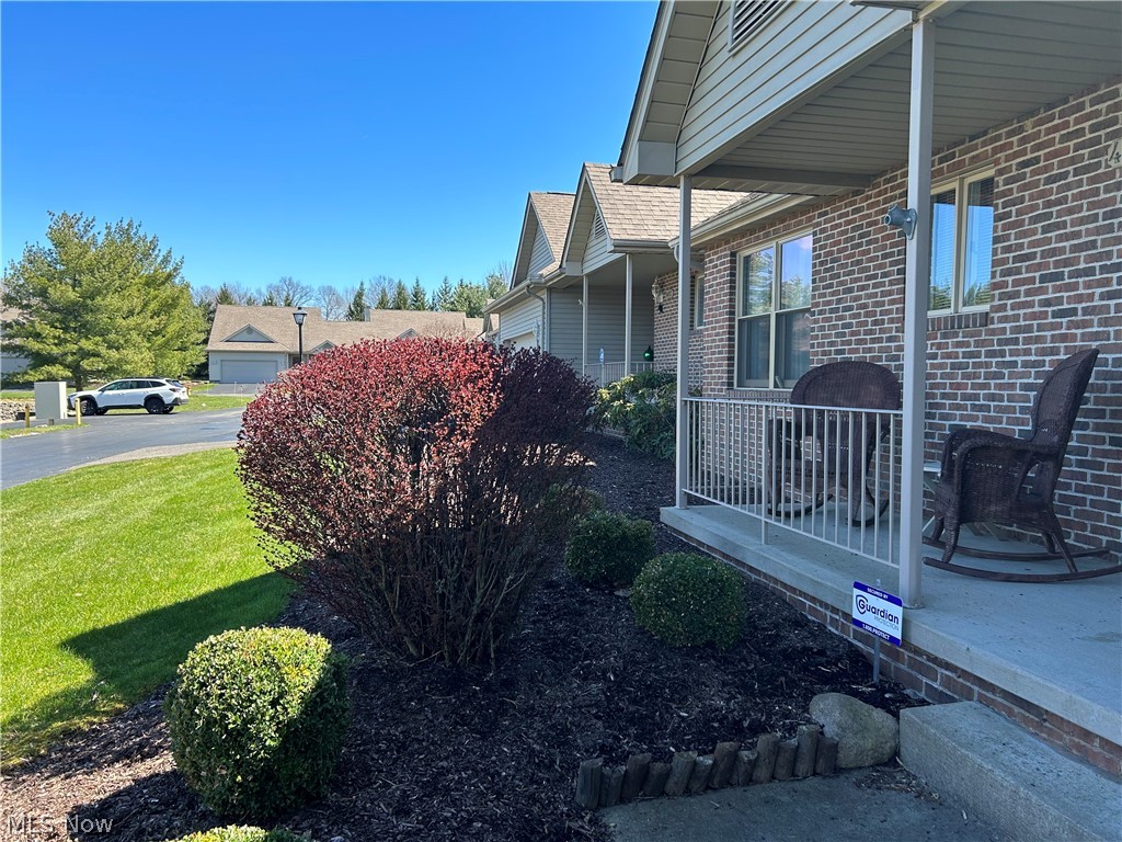 40 East Western Reserve Road, Unit 1 Youngstown, OH 44514 - Photo 32 of 33 View of property exterior featuring a yard and a porch. nice landscaping,