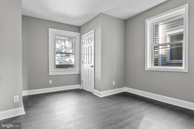 a view of a room with wooden floor and windows