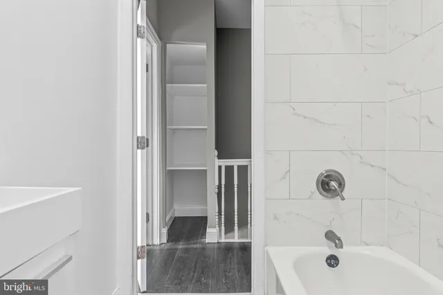 a bathroom with a tub and sink