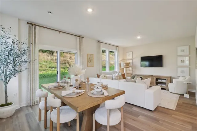 a view of a dining room with furniture window and wooden floor