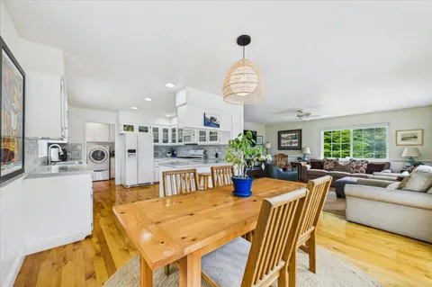 a kitchen with stainless steel appliances white cabinets and wooden floor