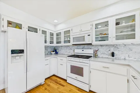 a kitchen with counter top space and windows