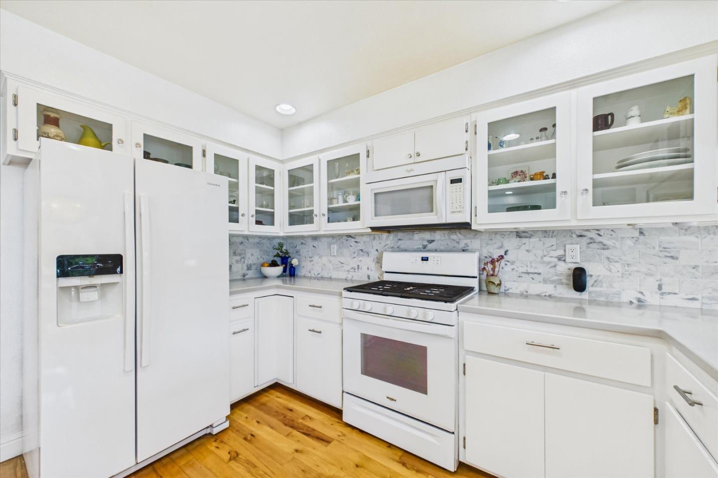 520 Redwood Road Whitethorn, CA 95589 - Photo 14 of 69 a kitchen with stainless steel appliances white cabinets and wooden floor