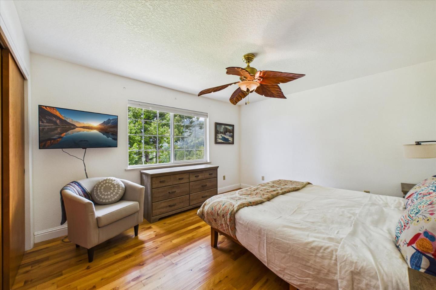 520 Redwood Road Whitethorn, CA 95589 - Photo 25 of 69 a bedroom with a bed and a chandelier