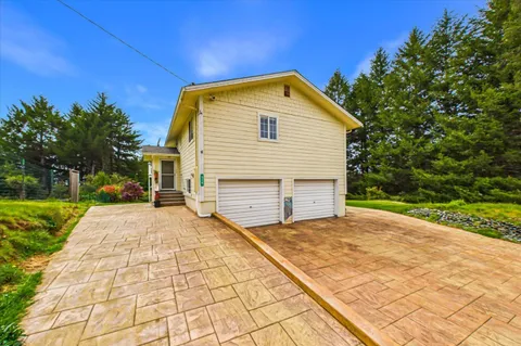 a front view of a house with a yard and seating area