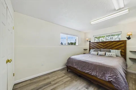 a balcony with wooden floor and yard in the back