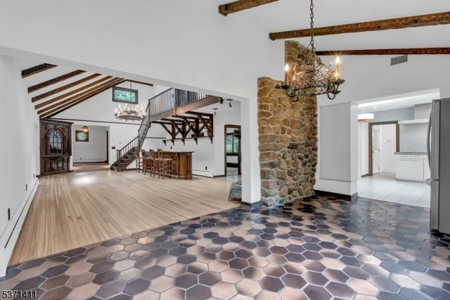 a very nice looking room with a large window and chandelier