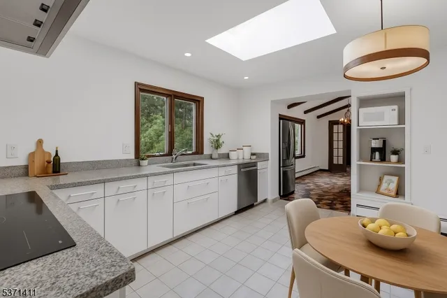 a kitchen with stainless steel appliances granite countertop a sink and a stove