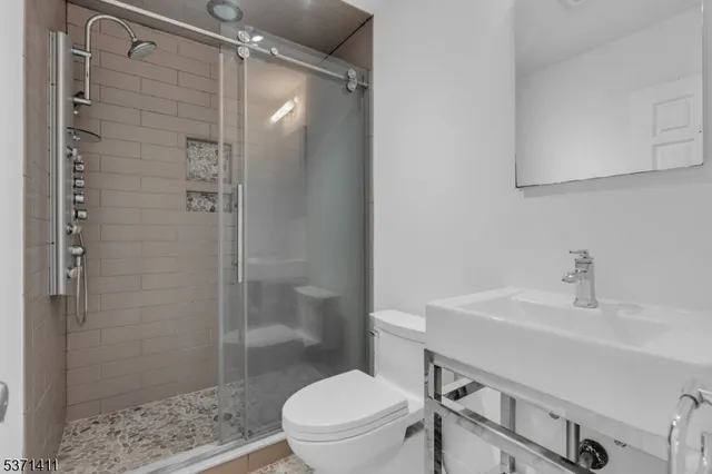 a bathroom with a sink toilet and shower