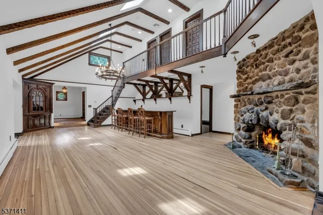 a view of a livingroom with wooden floor and a ceiling fan