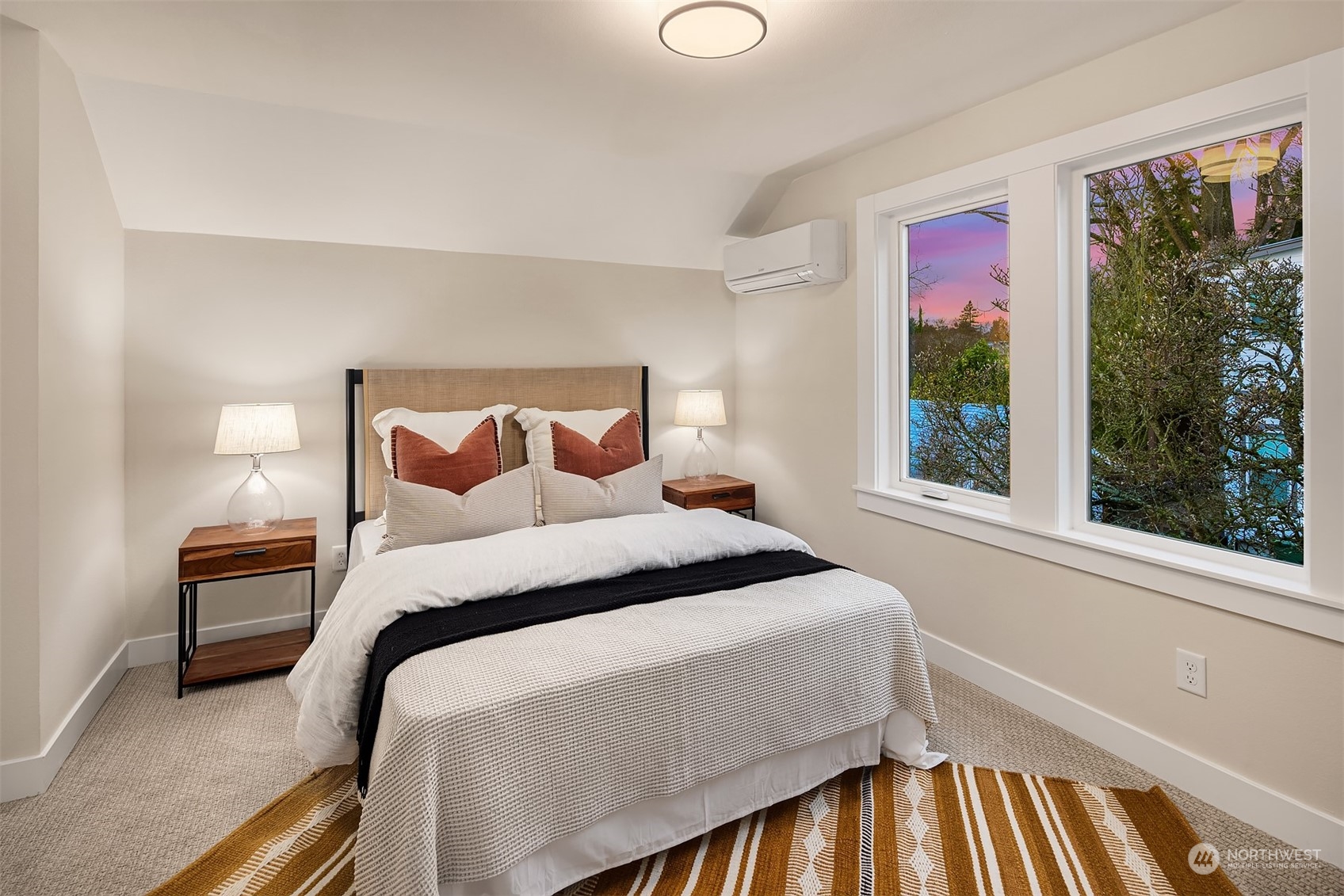8021 Wallingford Avenue North Seattle, WA 98103 - Photo 27 of 39 a bedroom with a bed and wooden floor
