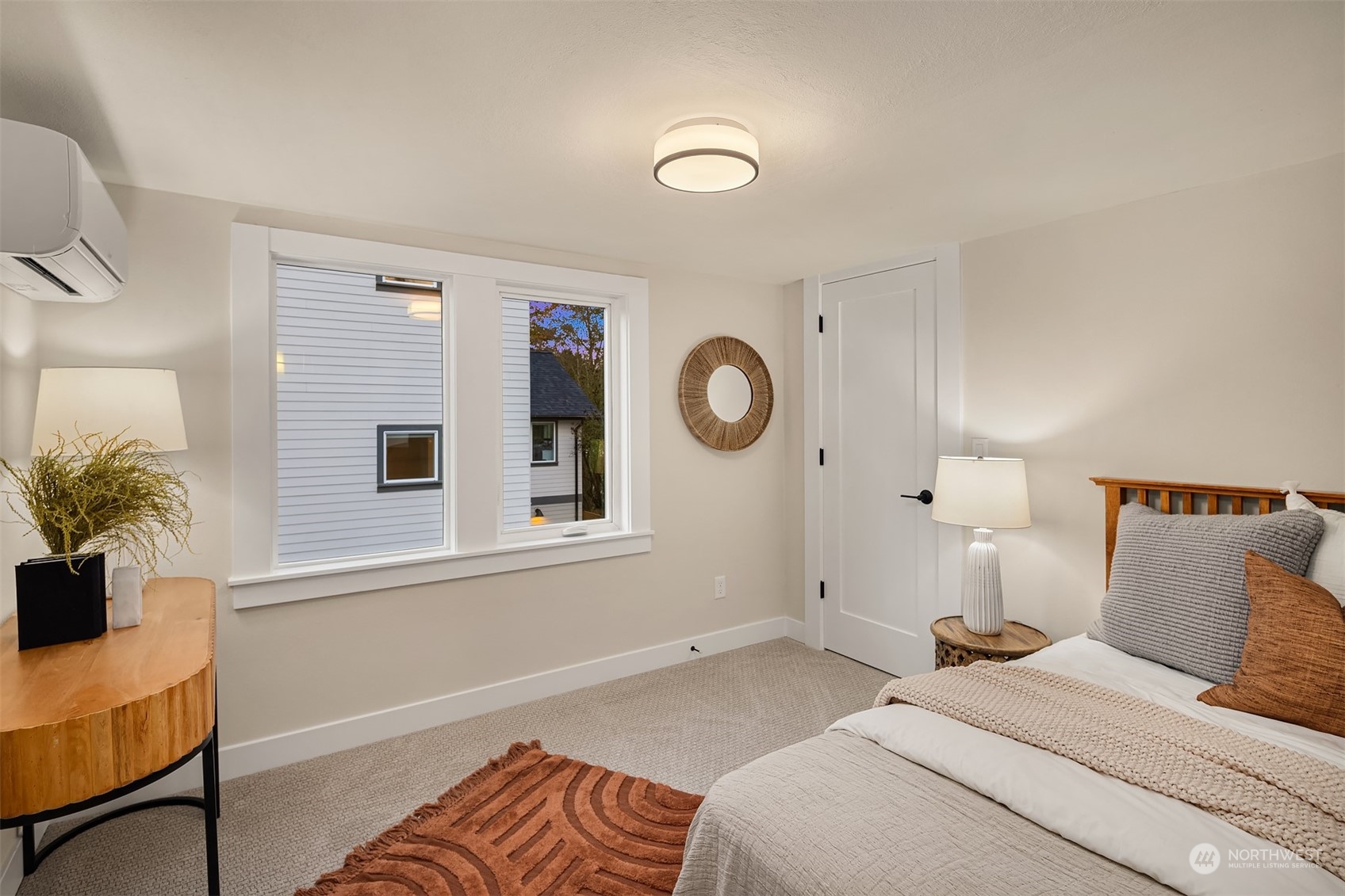 8021 Wallingford Avenue North Seattle, WA 98103 - Photo 30 of 39 a bedroom with a bed and a potted plant