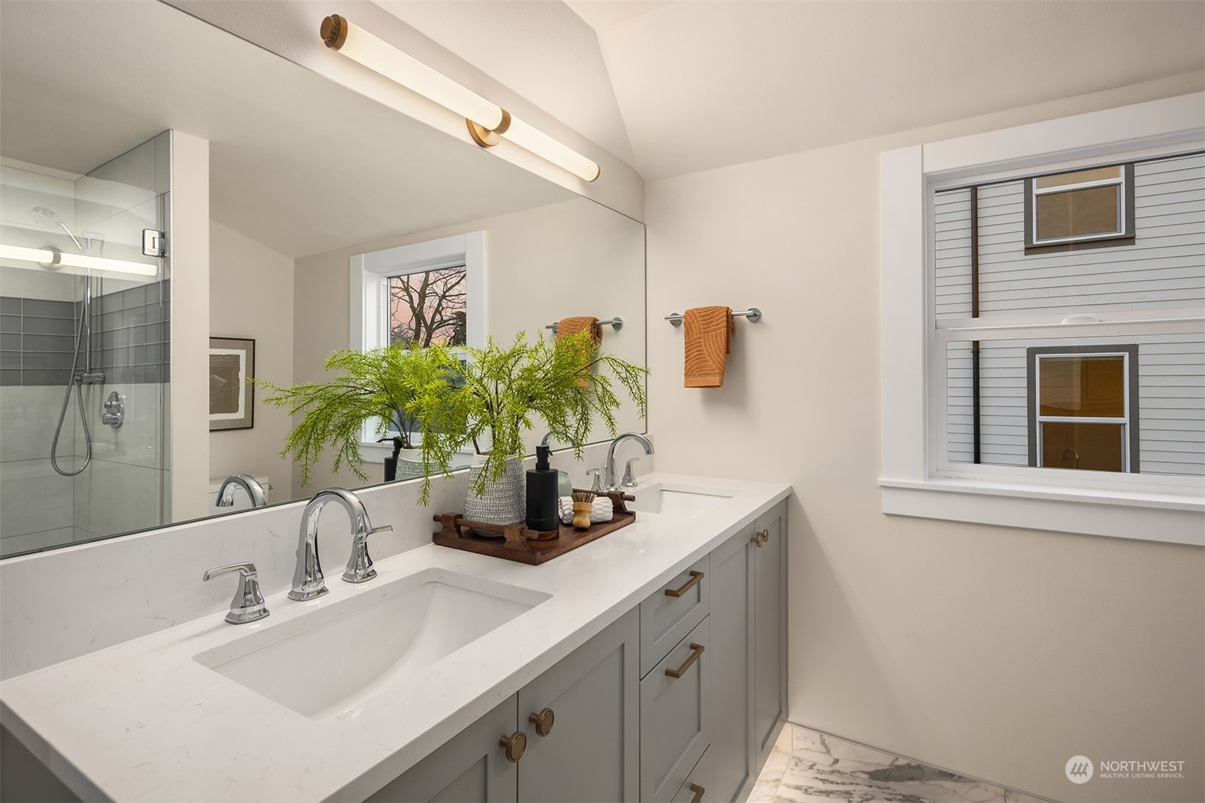8021 Wallingford Avenue North Seattle, WA 98103 - Photo 32 of 39 a bathroom with a sink a vanity and a mirror