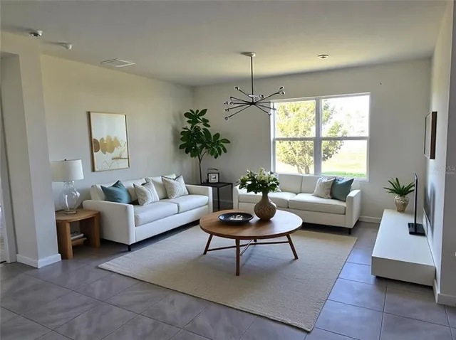 a living room with furniture and a large window