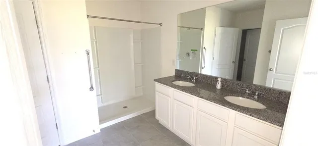 a bathroom with a granite countertop sink a mirror and a
